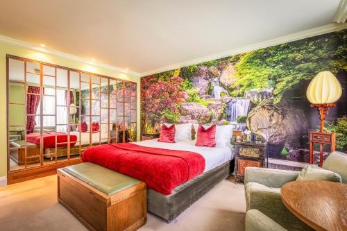 a bedroom with a large bed and a wall mural at St Michael's Manor Hotel - St Albans in St. Albans