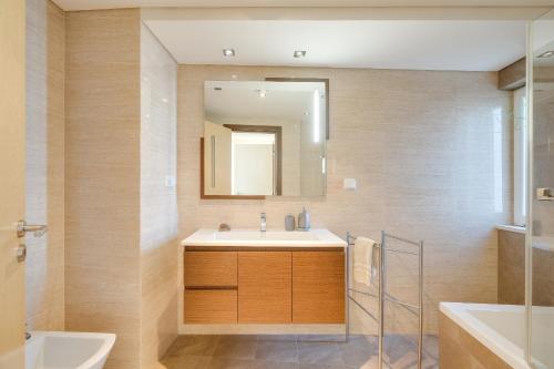 a bathroom with a sink and a mirror at luxury Plazza Sea view in Costa da Caparica