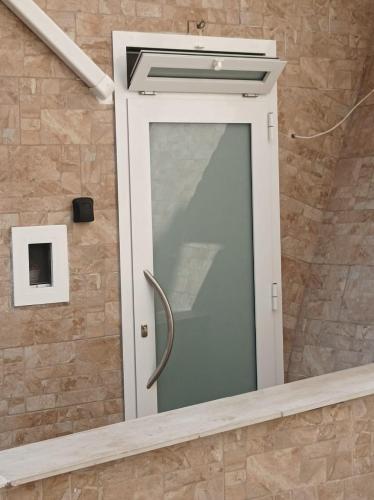 a shower with a glass door in a bathroom at Il sottano borgo antico in Bari