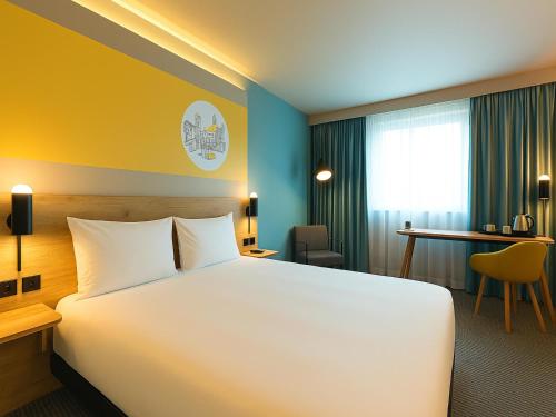 a hotel room with a bed and a desk at B&B HOTEL Inverness in Inverness