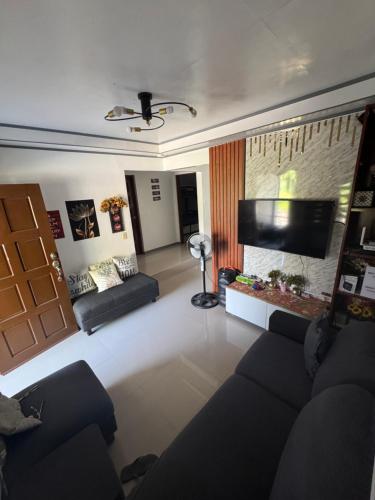 a living room with a couch and a flat screen tv at Lemery farmbeach Escape in Lemery