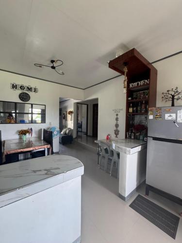 a kitchen with white counter tops and a refrigerator at Lemery farmbeach Escape in Lemery