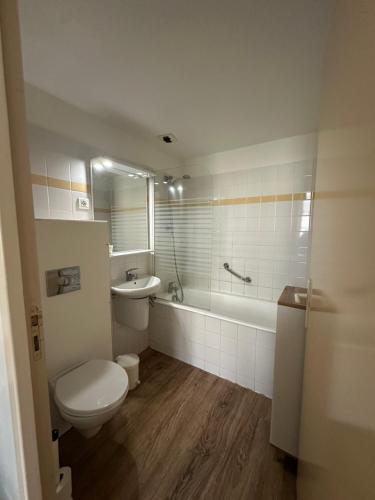 a bathroom with a toilet and a tub and a sink at Le Rhum Antik in Puybrun