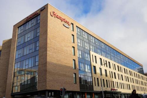 a building with a sign on the side of it at Hampton By Hilton Edinburgh West End in Edinburgh