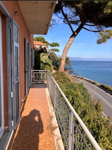 a shadow of a person taking a picture of the ocean at Verdazzurra in Bergeggi