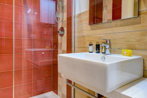 a bathroom with a white sink and a shower at Casa Vino - Gardagate in Salò