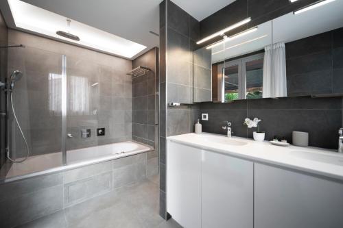 a bathroom with a tub and a sink and a shower at MyBlueVista LUXURY SEA VIEW PRIVATE VILLA CAP D AIL 200M MONACO in Cap d'Ail