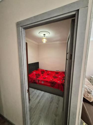 a bedroom with a bed with red sheets and roses at Apartment in Jermuk in Jermuk