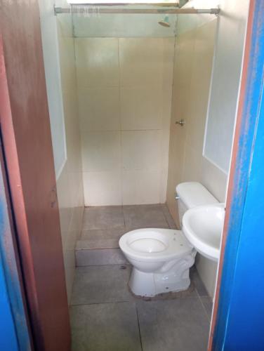 a bathroom with a toilet and a sink at Amazon Macambo Lodge in Iquitos