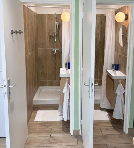 a bathroom with a tub and a sink and a shower at Sleep and Go Lyon Oullins in Oullins