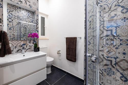 a bathroom with a toilet and a sink and a shower at V86 - Charming 1 Bedroom Isla Duplex Apt with Harbour Views in Senglea