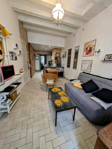 a living room with a couch and a table at La Chancellerie in Loches