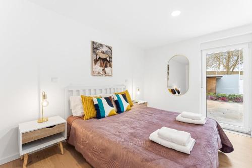 a bedroom with a large bed with two towels on it at A unique experience in Porto in Porto