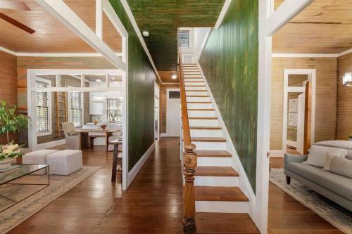 a staircase in a house with a living room at Rustic Luxury - As Seen on "Restoring Galveston" TV Show in Galveston