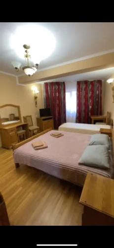 a bedroom with a large bed in a room at Готель Ніколет in Mukacheve