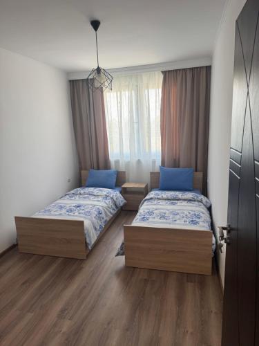a bedroom with two beds and a window at Kennedy House in Lyetnitsa