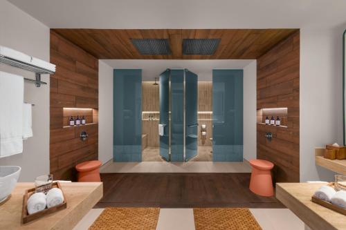 a bathroom with a shower and two toilets at Hilton Cancun Mar Caribe All-Inclusive Resort in Cancún