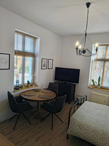 a living room with a table and chairs and a couch at Apartament Wieżyczka in Świdnica