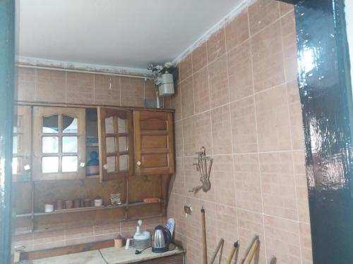 a bathroom with a sink and a tiled wall at شقة فاخرة موقع ممتاز in Aswan