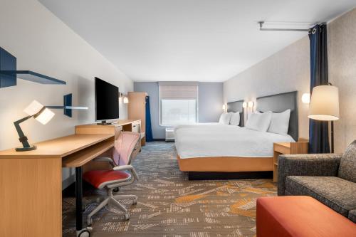 a hotel room with a bed and a desk at Home2 Suites by Hilton Irving/DFW Airport North in Irving