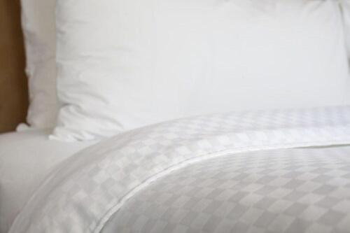 a white bed with white sheets and pillows at Four Points by Sheraton Midland in Midland