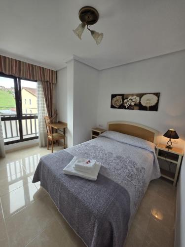 a bedroom with a bed with a tray on it at Hostal Restaurante Piedra in Limpias