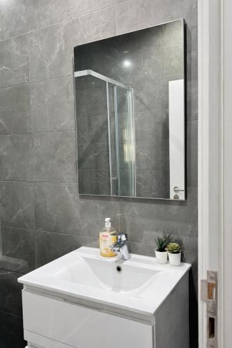 a bathroom with a white sink and a mirror at Velvet Prime Stay in Lisbon