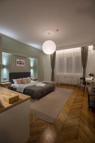 a bedroom with a bed and a living room at High Note Suites in Belgrade