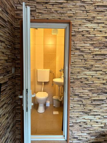 a bathroom with a toilet and a sink at Guest house Kozle in Skopje