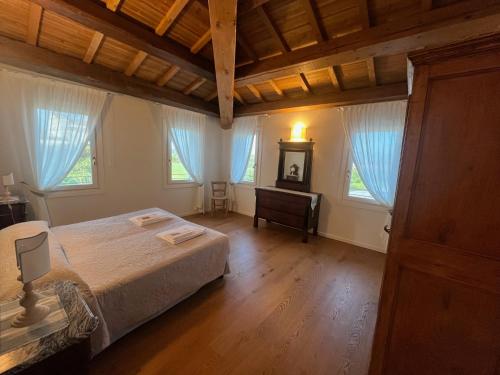 a bedroom with a bed in a room with windows at Villa Ghislanzoni in Vicenza