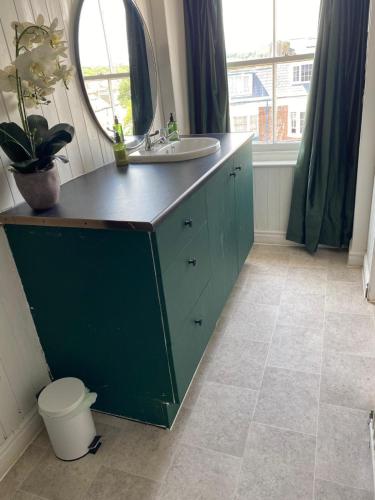 a bathroom with a sink and a mirror at Sea view Penthouse flat 6 with fast WiFi and Free PARKING in Scarborough