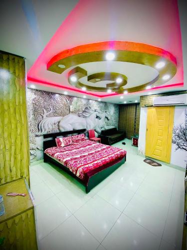 a bedroom with a bed with a painting on the wall at One bed lovely apartment in Rawalpindi