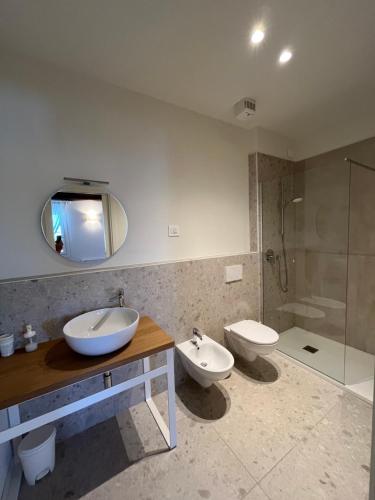 a bathroom with two toilets and a sink and a shower at Villa Ghislanzoni in Vicenza