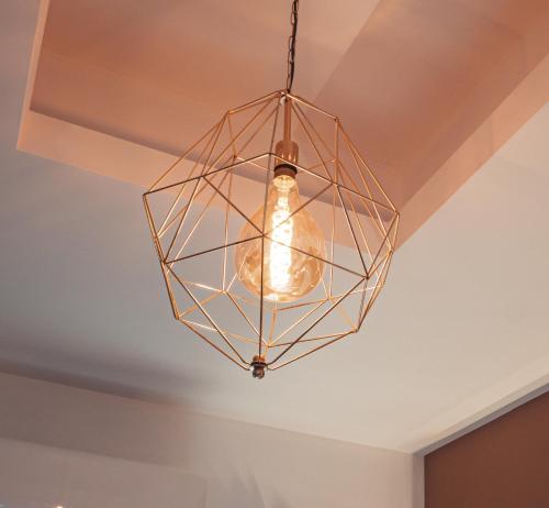 a glass light fixture hanging from a ceiling at The Arundell Hotel in Boston