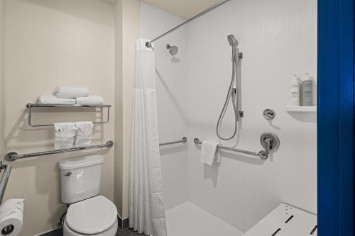 a bathroom with a shower and a toilet at Spark By Hilton Fort Wayne in Fort Wayne