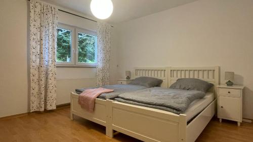 a bedroom with a bed and a window at Ferienwohnung Karl May in Lennestadt