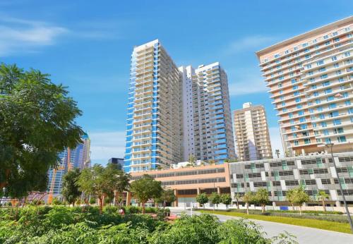 a group of tall buildings in a city at CaiCai Homes AG Tower-Business Bay in Dubai
