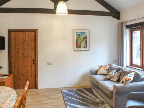 a living room with a couch and a table at Byre Cottage - Uk50028 in Liskeard