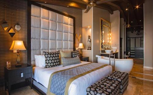 a bedroom with a large bed with a large window at Suites at Zona Romantica in Puerto Vallarta