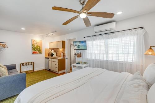 a bedroom with a white bed and a ceiling fan at HIDEAWAY @ Speakeasy Inn Key West! in Key West