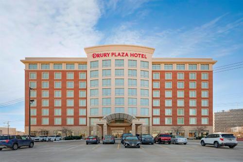 a hotel with cars parked in a parking lot at Drury Plaza Hotel St Louis Brentwood in Brentwood