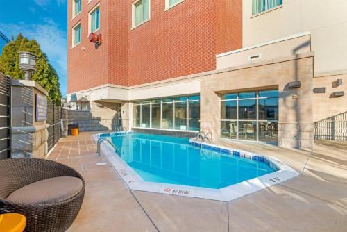 a swimming pool in front of a building at Drury Plaza Hotel St Louis Brentwood in Brentwood