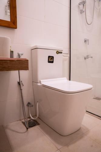 a white toilet in a bathroom with a shower at Nest & Rest in Sri Jayewardenepura Kotte