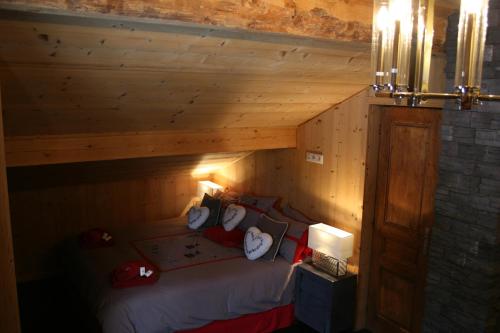 a room with a bed in a wooden cabin at La Chanterelle - Mountain Lodge in La Côte dʼArbroz