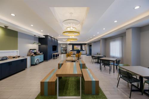 an office lobby with tables and chairs and a cafeteria at Spark by Hilton Midland South in Midland
