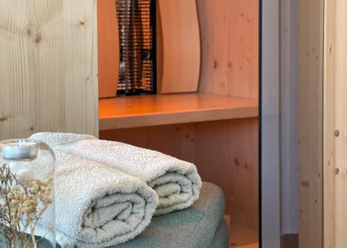 a room with a table with a towel on a chair at Ferienwohnung Zirbenglück in Siegsdorf