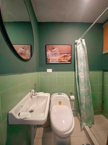 a bathroom with a toilet and a sink and a mirror at Cossy studio apartment in downtown in Cuenca