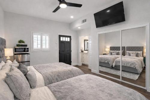 a bedroom with two beds and a large mirror at Calabasas Hillside 1BD Hideaway Retreat in Woodland Hills