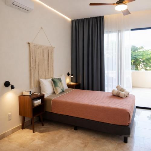 a bedroom with a large bed and a window at NEW 2 bed swim-up, gril with jacuzzi Aldea Zamá in Tulum
