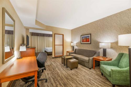 a hotel room with a couch and a desk at Drury Plaza Hotel St Louis Brentwood in Brentwood